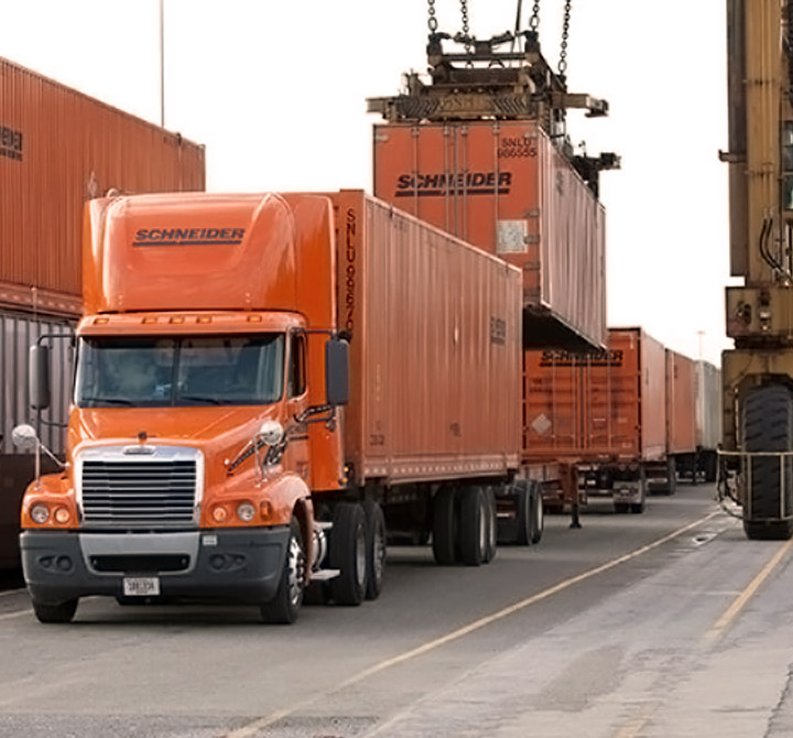 Schneider freight trucks being loaded.